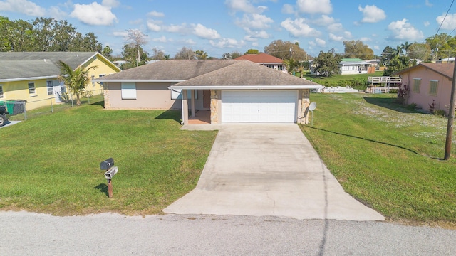 ranch-style home with a garage, fence, stone siding, a residential view, and a front lawn