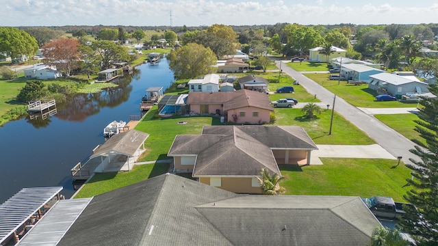 birds eye view of property with a residential view and a water view