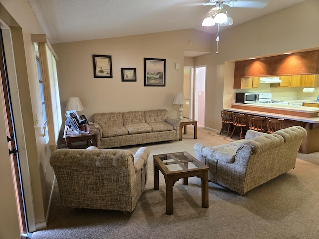 living room with lofted ceiling, light carpet, ceiling fan, and baseboards