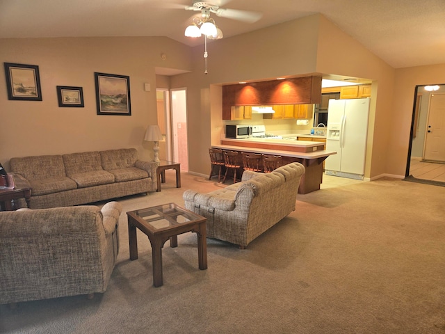 carpeted living room featuring vaulted ceiling, ceiling fan, and sink