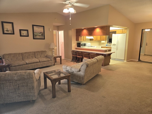 living room with lofted ceiling, light colored carpet, ceiling fan, and baseboards