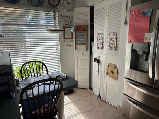 kitchen featuring stainless steel fridge and light tile patterned floors