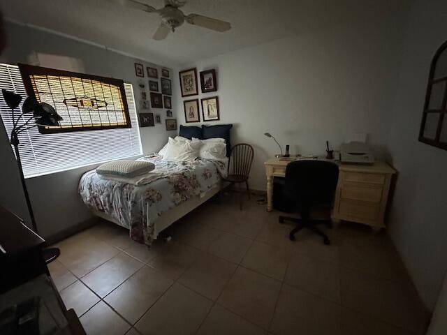 tiled bedroom with ceiling fan