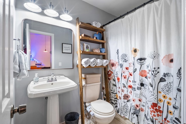 bathroom featuring walk in shower and toilet