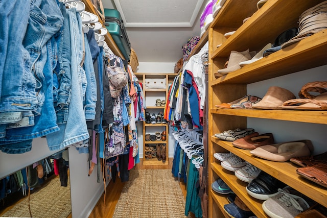 walk in closet with light wood-type flooring