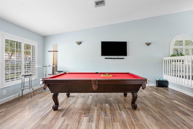 playroom featuring plenty of natural light, wood-type flooring, and vaulted ceiling