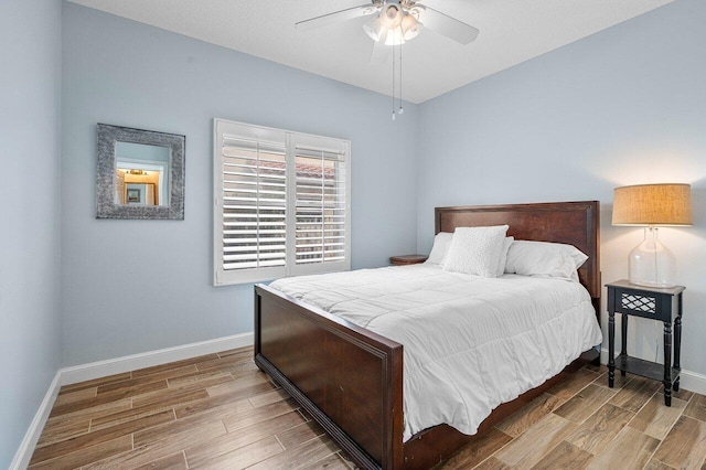 bedroom featuring ceiling fan and light hardwood / wood-style flooring