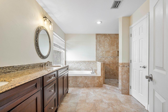 bathroom with vanity, separate shower and tub, and tile walls