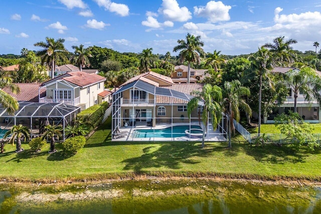 back of property with an outdoor pool, a patio, a tile roof, a lanai, and a yard