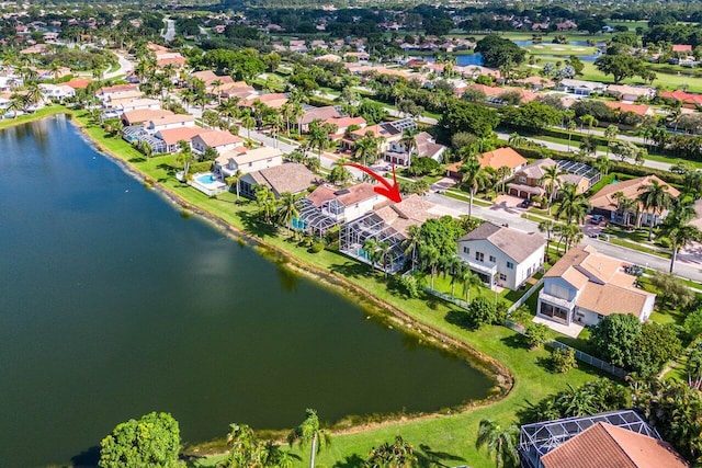 drone / aerial view featuring a water view and a residential view