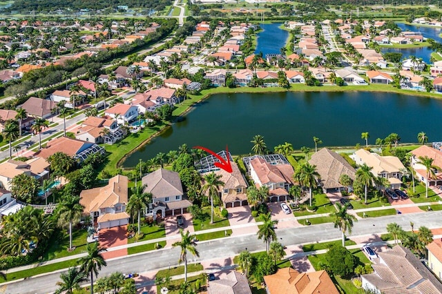 bird's eye view featuring a residential view and a water view