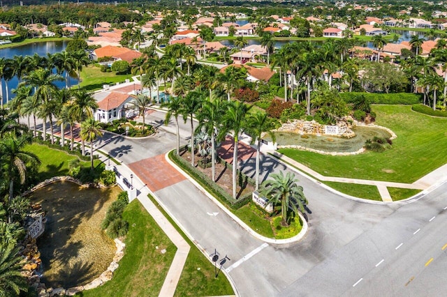 drone / aerial view featuring a residential view and a water view