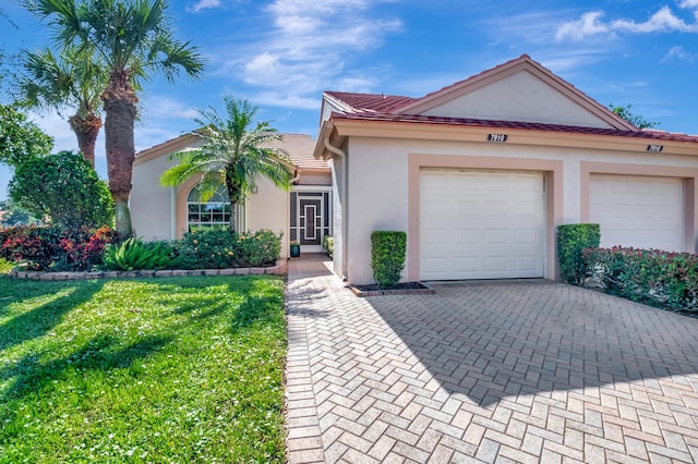 view of front of home with a garage and a front lawn