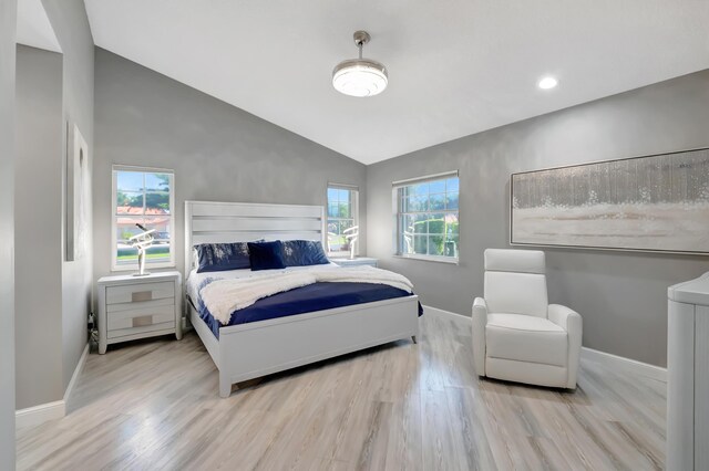 tiled living room with a wealth of natural light, ceiling fan, and vaulted ceiling