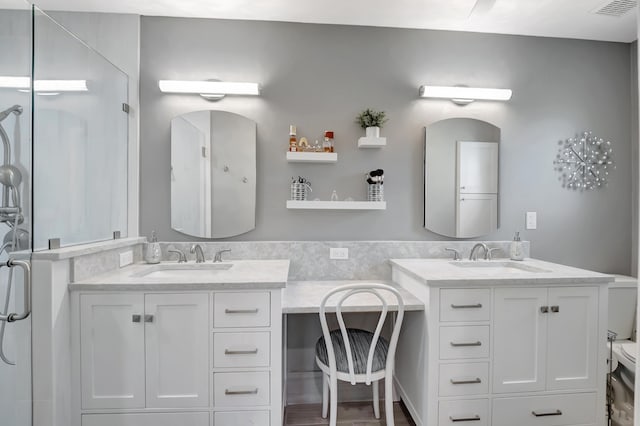 bathroom featuring vanity, hardwood / wood-style flooring, and a shower with shower door