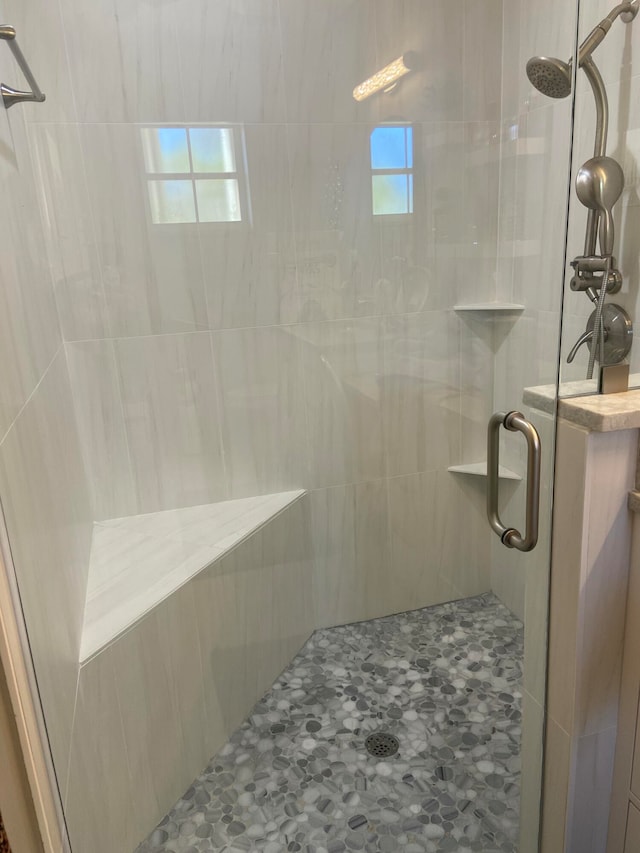 bathroom with a shower with door