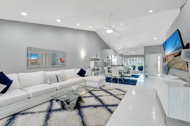 tiled dining area featuring ceiling fan and high vaulted ceiling