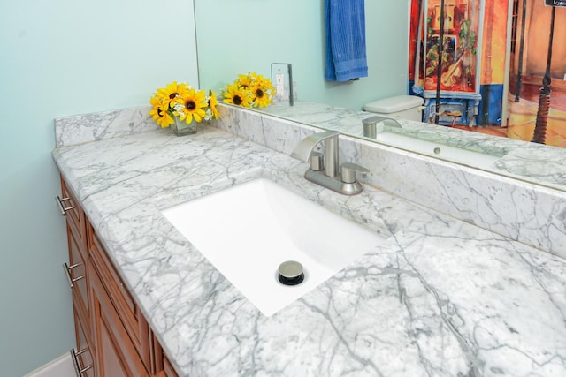 bathroom with vanity and toilet