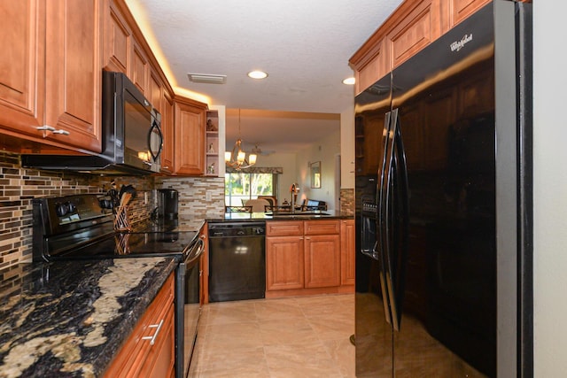 kitchen with backsplash, dark stone counters, a notable chandelier, and black appliances