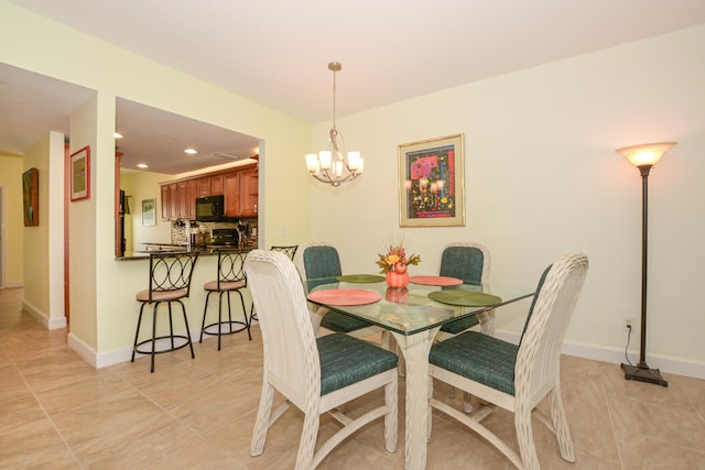 tiled dining room with an inviting chandelier