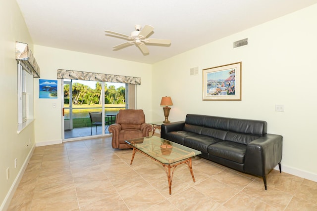 living room with ceiling fan and light tile patterned floors