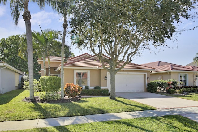 view of front of home with a front yard and a garage