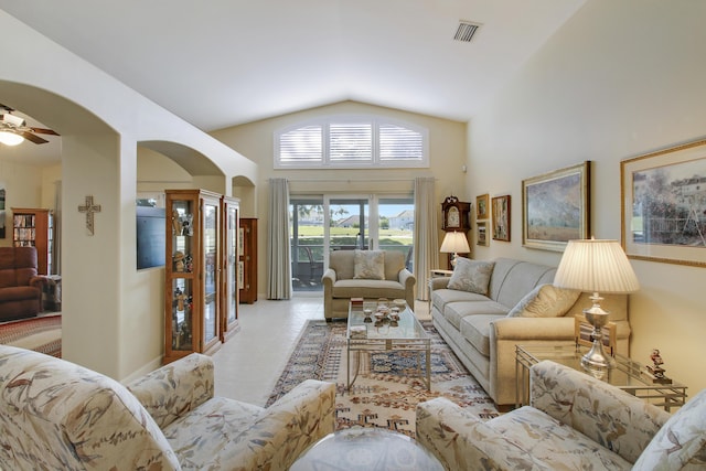 tiled living room featuring ceiling fan and lofted ceiling