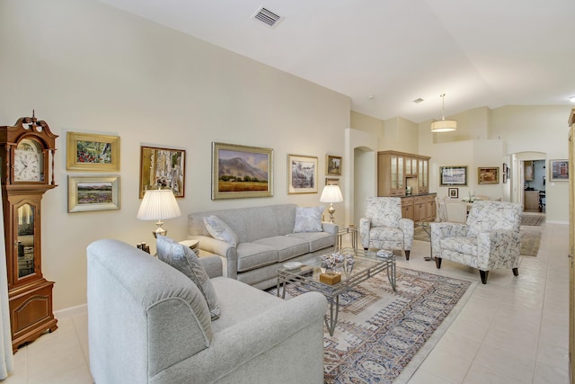 living room featuring light tile patterned floors and vaulted ceiling