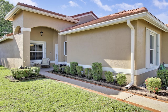 mediterranean / spanish house with a front lawn