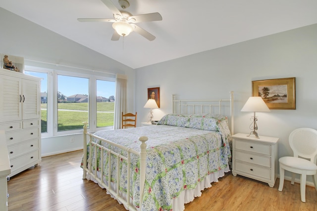 bedroom featuring light hardwood / wood-style floors, ceiling fan, and lofted ceiling