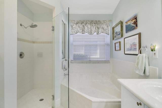 bathroom with vanity and independent shower and bath