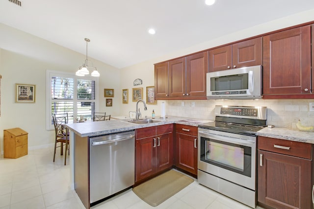 kitchen featuring sink, hanging light fixtures, a notable chandelier, kitchen peninsula, and appliances with stainless steel finishes