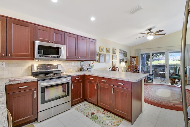 kitchen with backsplash, kitchen peninsula, stainless steel appliances, and vaulted ceiling