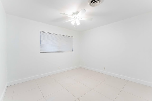 unfurnished room featuring light tile patterned floors and ceiling fan