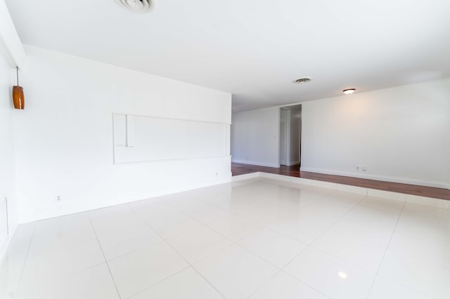 unfurnished room with light tile patterned floors