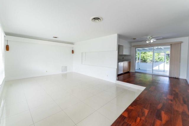 empty room featuring ceiling fan and light hardwood / wood-style flooring