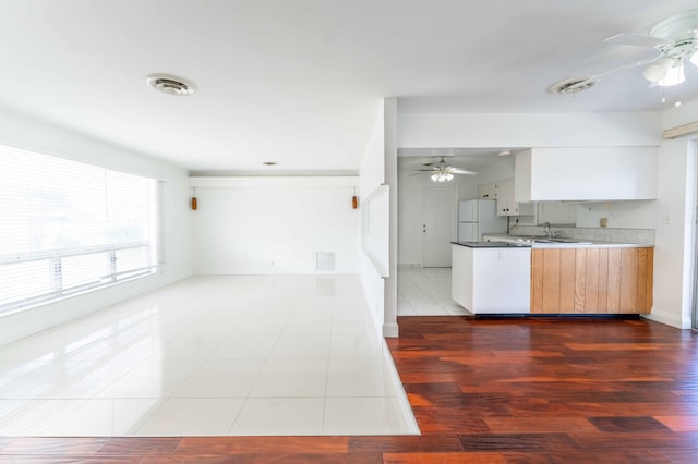 kitchen with ceiling fan, sink, white refrigerator, light hardwood / wood-style flooring, and white cabinets