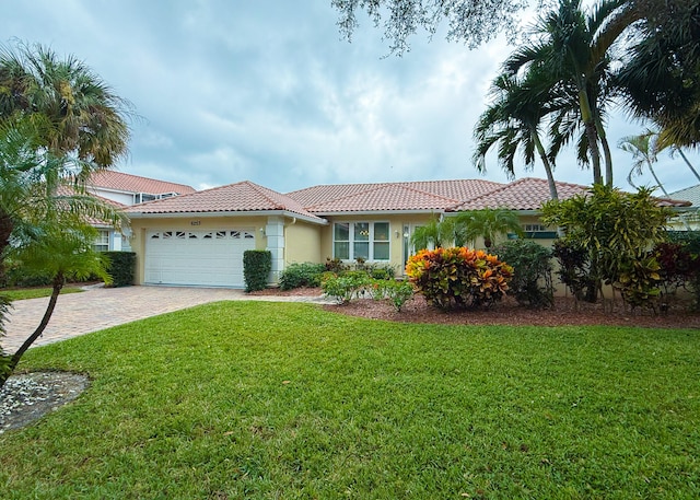 view of front of home featuring a garage and a front lawn