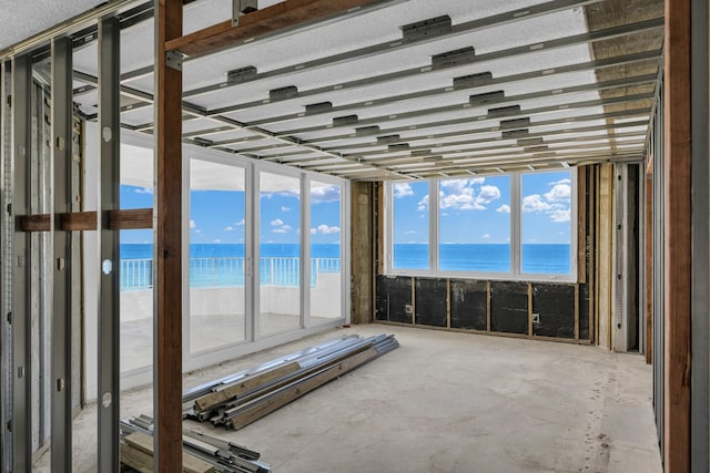 misc room with a view of the beach and a water view