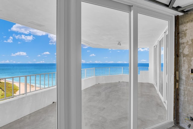 interior space featuring a beach view and a water view