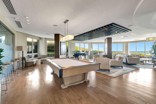 playroom with wood-type flooring, a wealth of natural light, and billiards