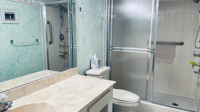 bathroom with vanity, an enclosed shower, and toilet