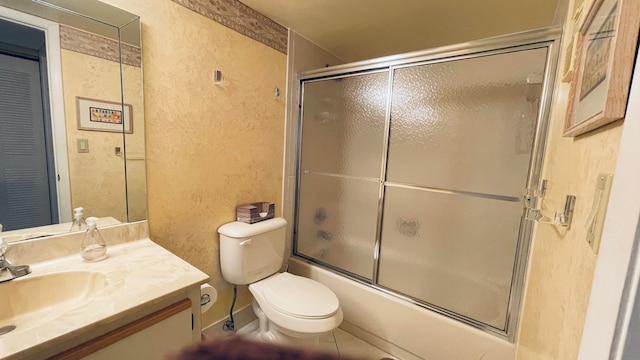 full bathroom featuring tile patterned flooring, toilet, vanity, and combined bath / shower with glass door