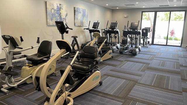 workout area with carpet and a drop ceiling