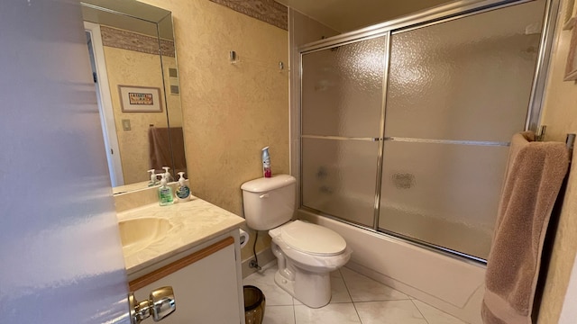 full bathroom with tile patterned floors, vanity, enclosed tub / shower combo, and toilet