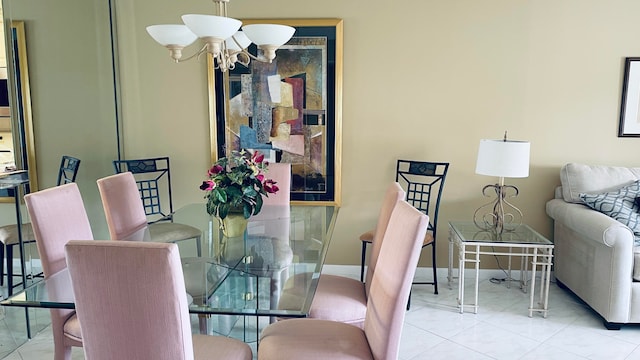 tiled dining room featuring an inviting chandelier