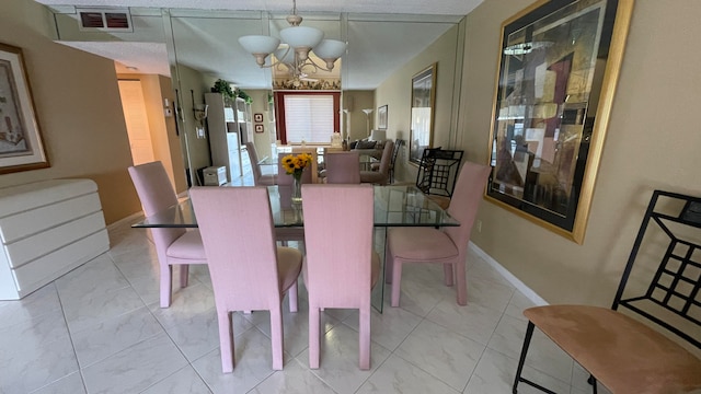 dining room with a notable chandelier and a textured ceiling