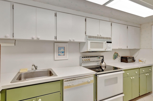 kitchen with white cabinetry, sink, green cabinets, white appliances, and light tile patterned flooring