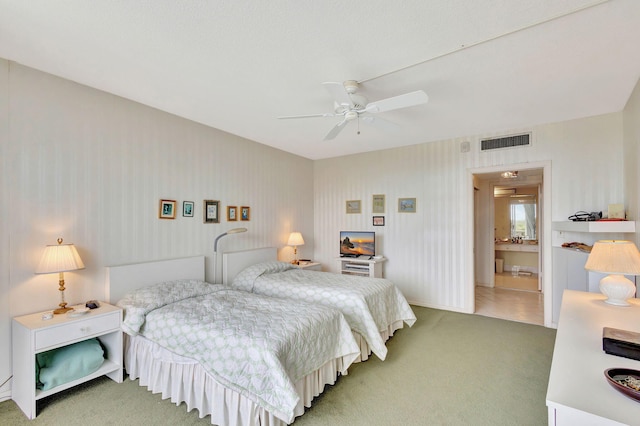 bedroom featuring carpet flooring, ceiling fan, and ensuite bathroom