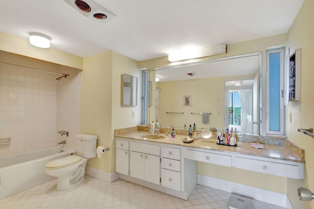 full bathroom featuring tiled shower / bath, tile patterned flooring, vanity, and toilet